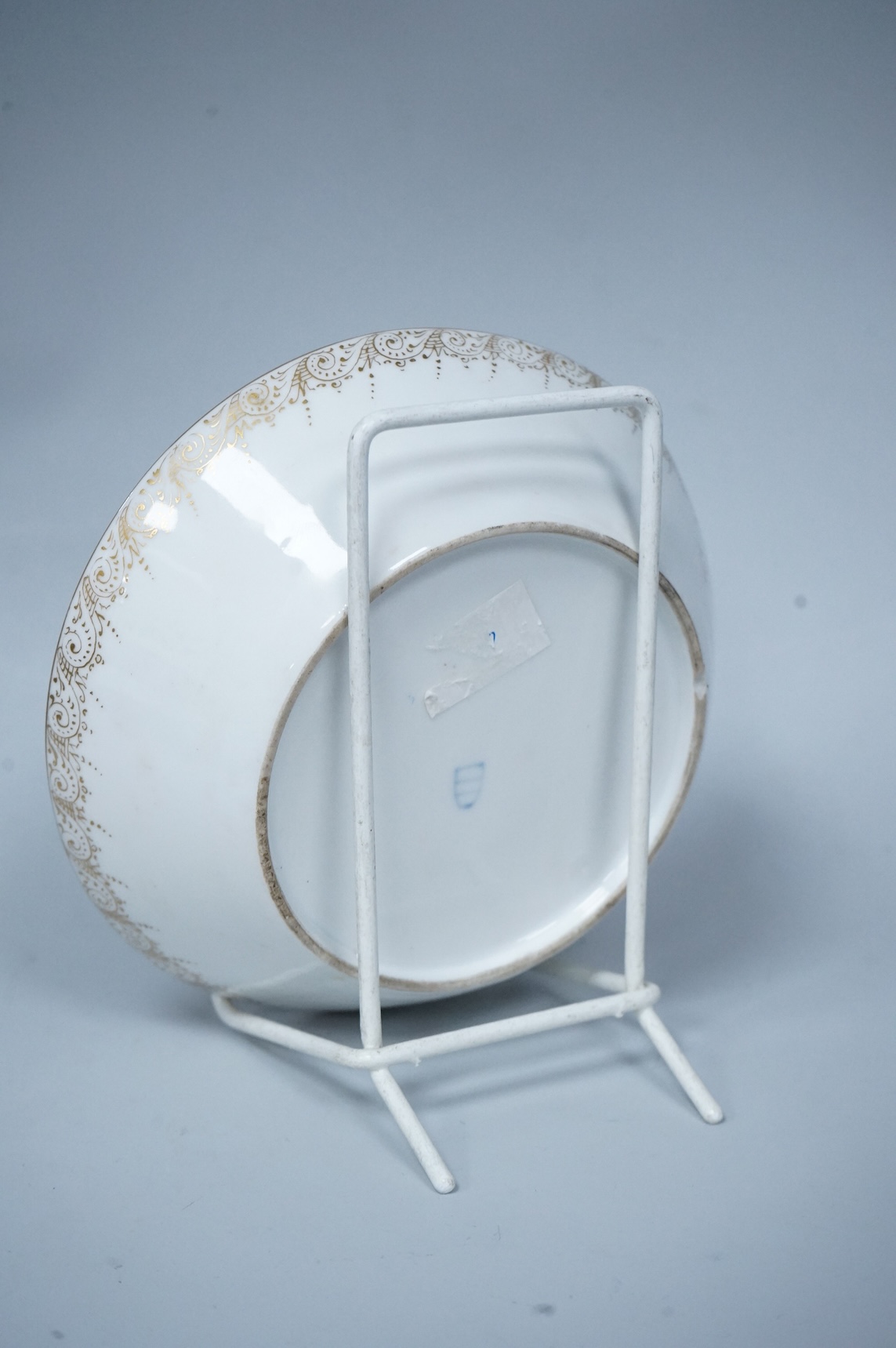 A 19th century Vienna saucer, hand painted with two figures beneath a tree, 15cm in diameter